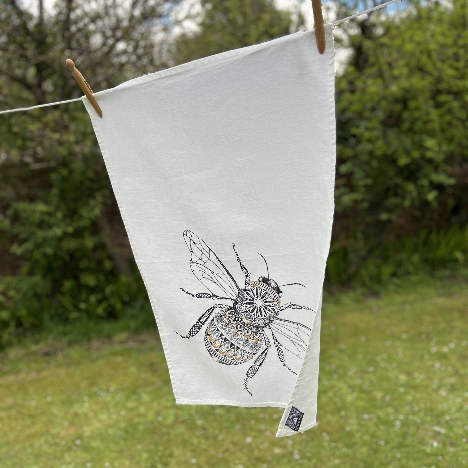 Honey bee in Charcoal and Gold on White Linen - On the line